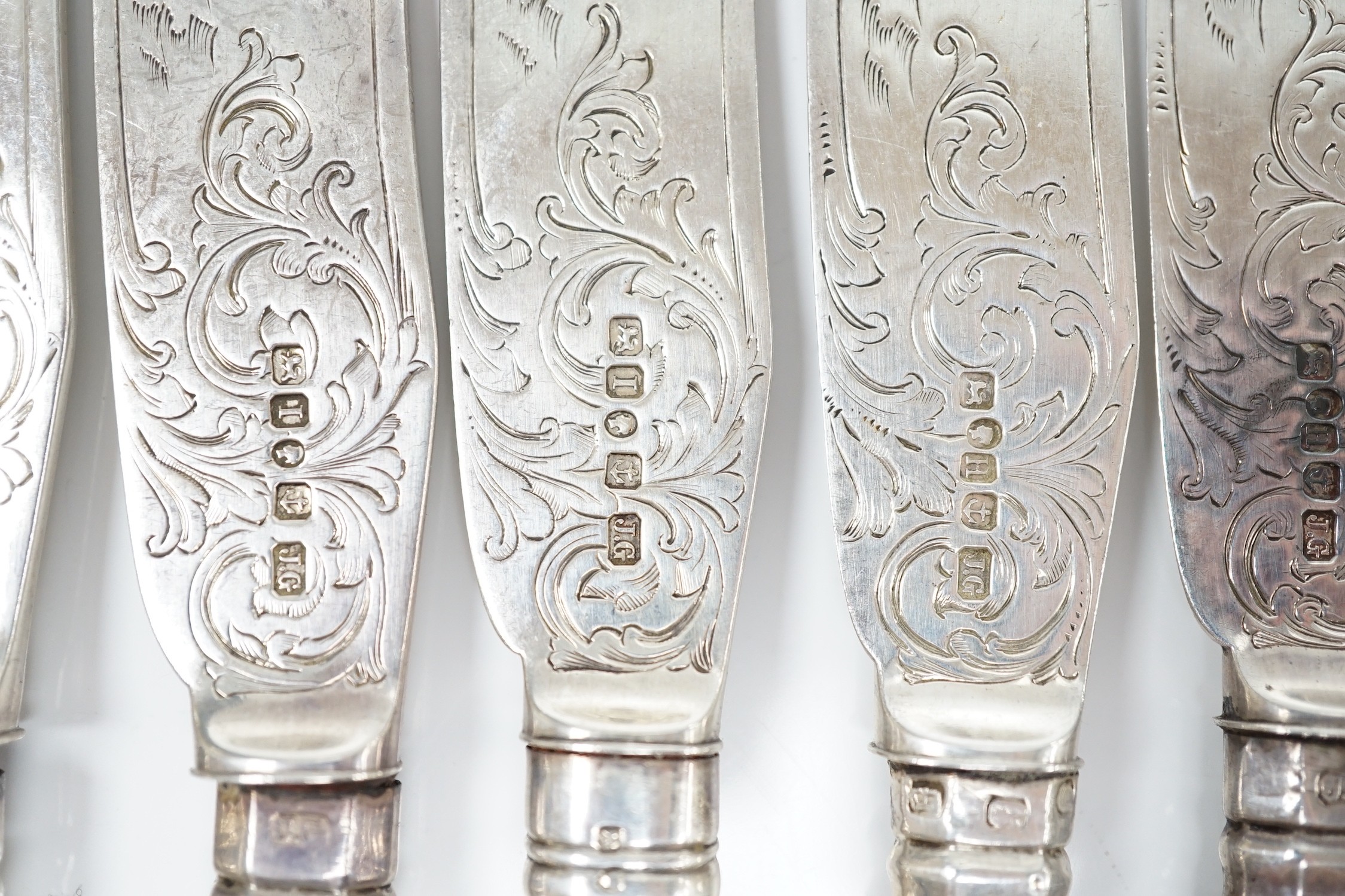 A set of ten pairs of Victorian silver Queen's pattern dessert eaters, maker, JG, Birmingham, 1856/7, loaded handles.